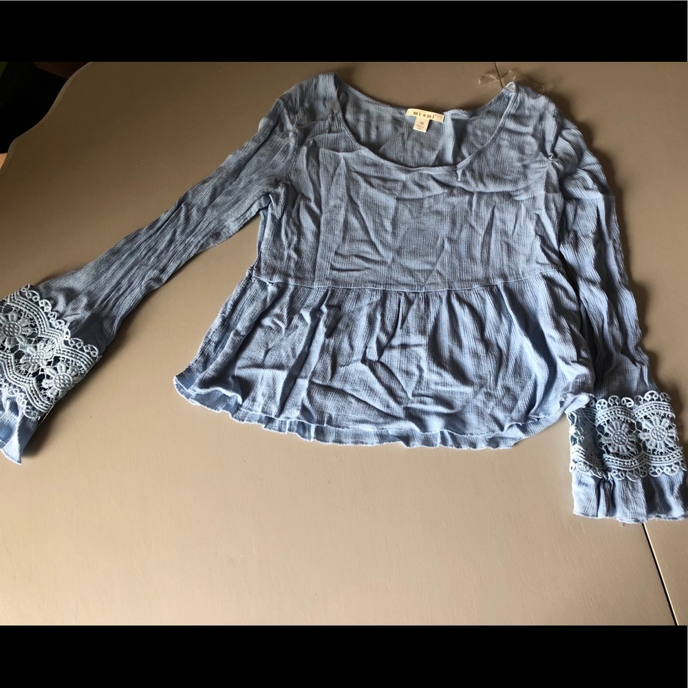 Blue top with bell sleeves and crochet details